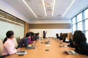 a group of people having a meeting in a conference room